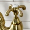 Kingston Brass Heirloom French Country Two-Handle 3-Hole Deck Mount Bridge Kitchen Faucet with Brass Sprayer