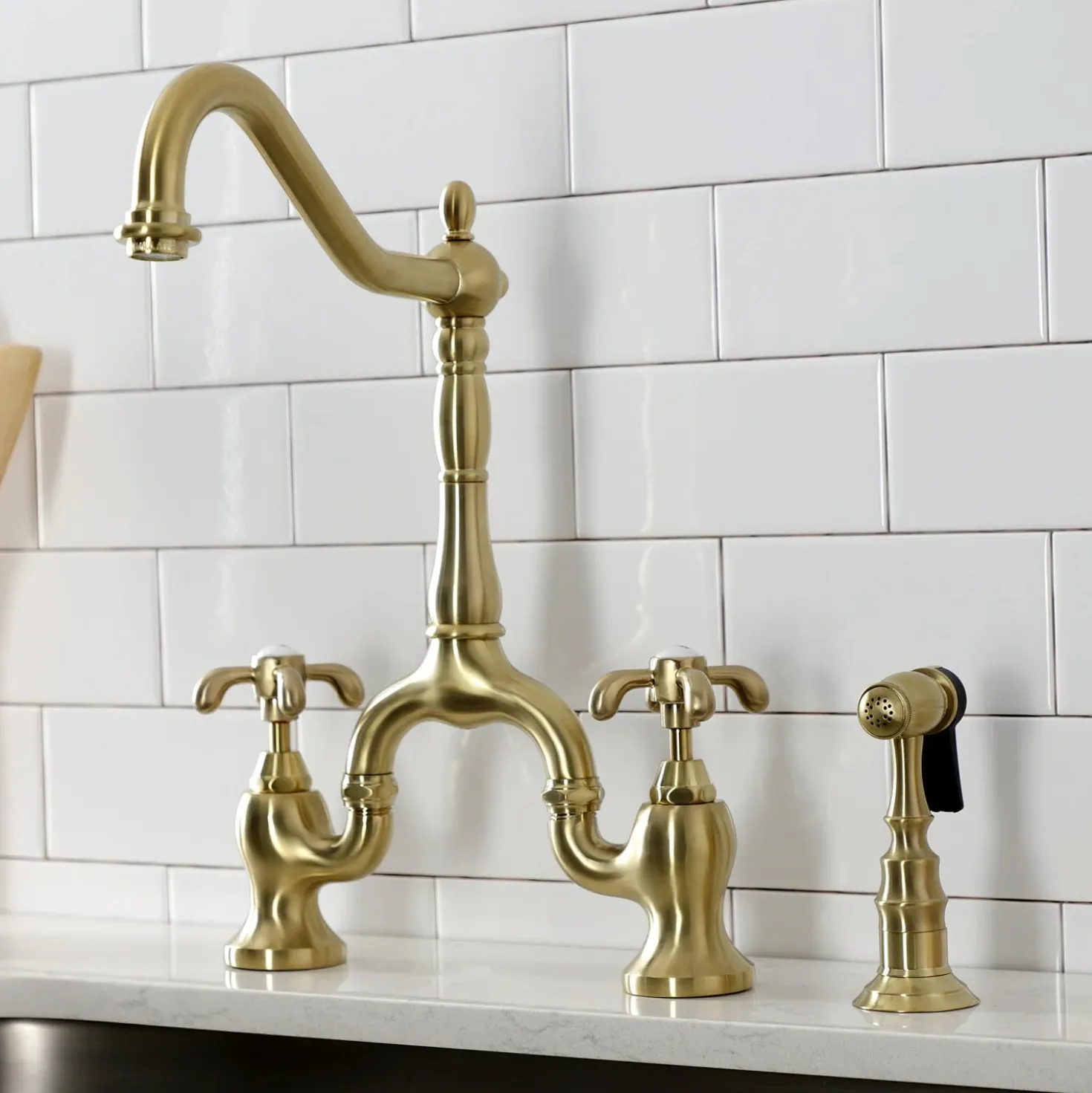 Kingston Brass Heirloom French Country Two-Handle 3-Hole Deck Mount Bridge Kitchen Faucet with Brass Sprayer