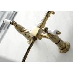Kingston Brass KS124XPLBS-P Heritage Two-Handle Wall Mount Bridge Kitchen Faucet with Brass Sprayer