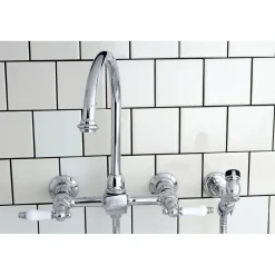 Kingston Brass Restoration Wall Mount 8-Inch Centerset Kitchen Faucet with Brass Sprayer