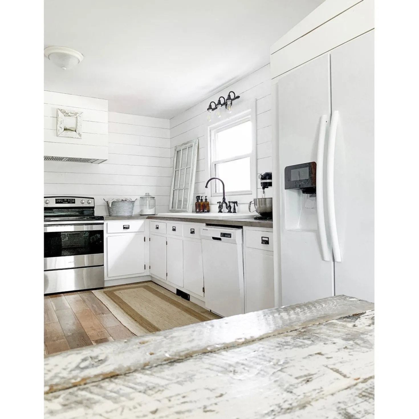 Kingston Brass Tudor Bridge Deck Mount Kitchen Faucet with Brass Sprayer
