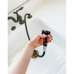 Kingston Brass Tudor Bridge Deck Mount Kitchen Faucet with Brass Sprayer