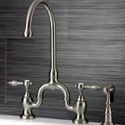 Kingston Brass Tudor Bridge Deck Mount Kitchen Faucet with Brass Sprayer