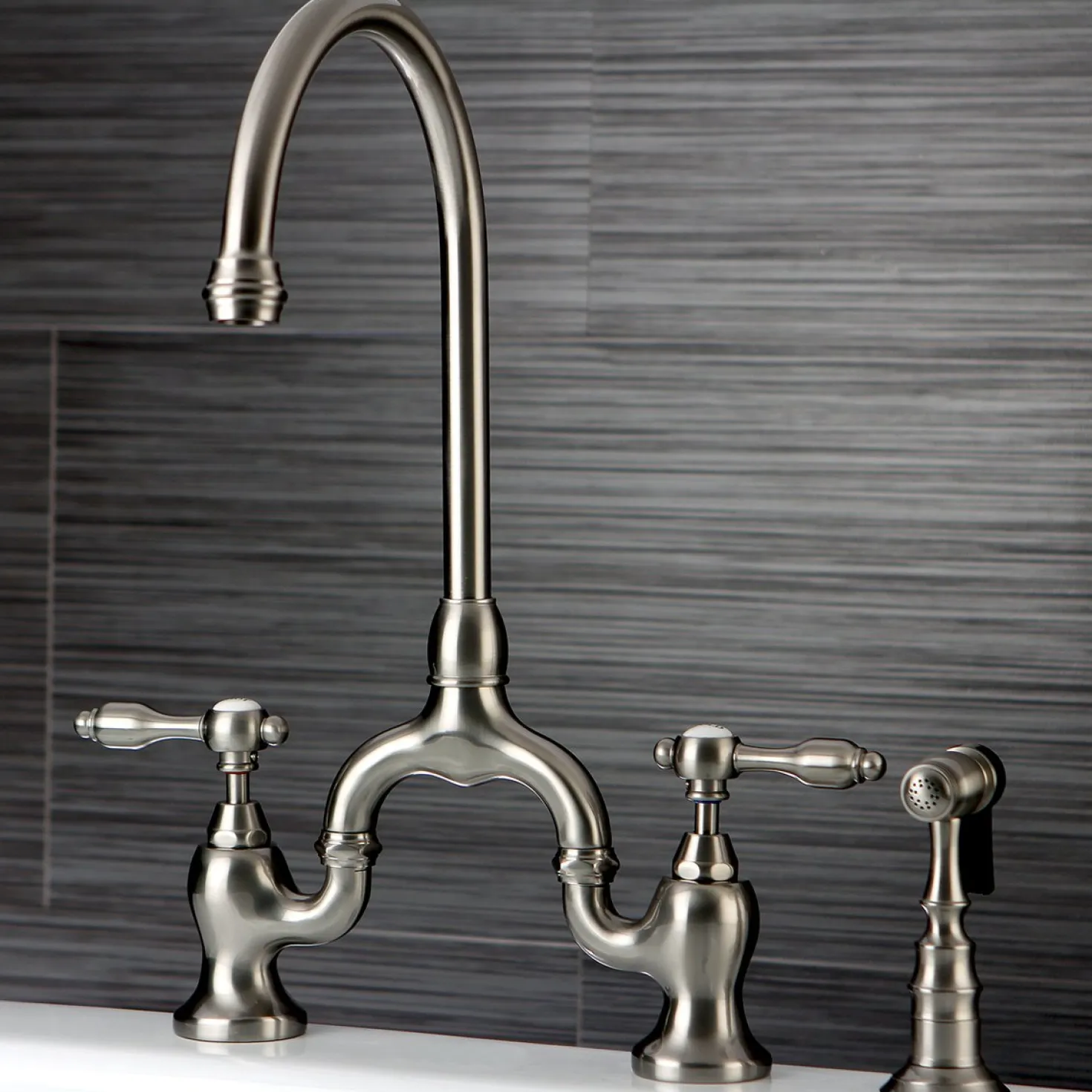 Kingston Brass Tudor Bridge Deck Mount Kitchen Faucet with Brass Sprayer