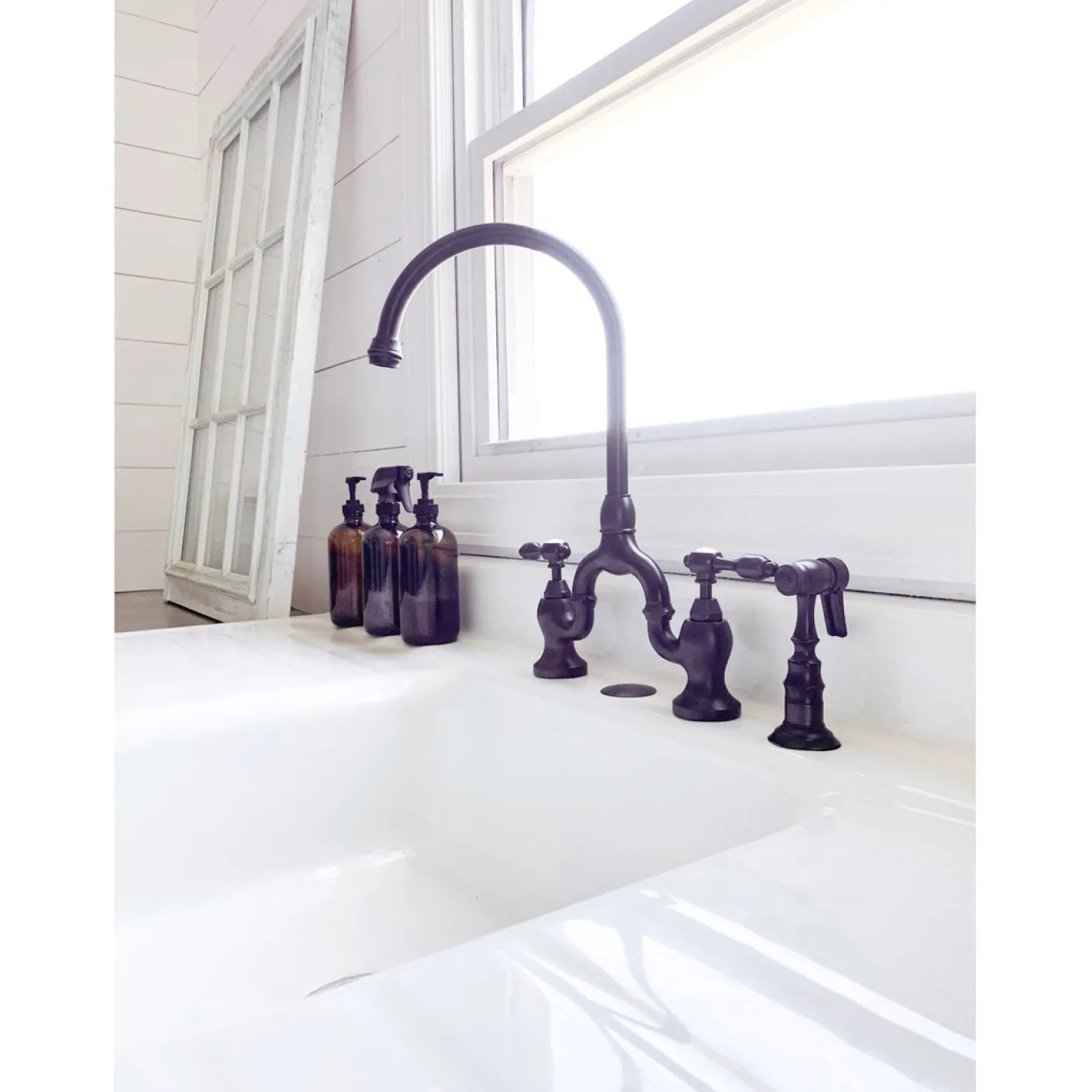 Kingston Brass Tudor Bridge Deck Mount Kitchen Faucet with Brass Sprayer
