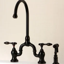 Kingston Brass Tudor Bridge Deck Mount Kitchen Faucet with Brass Sprayer