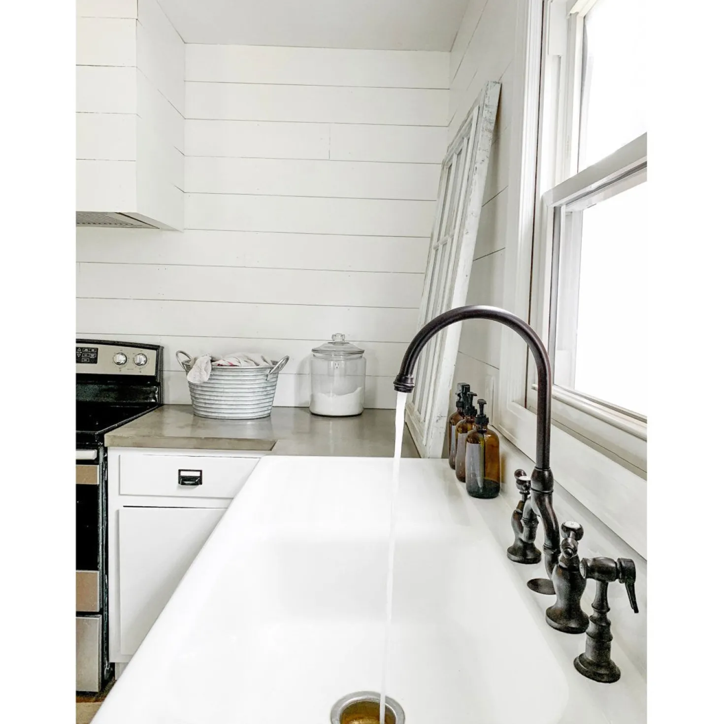 Kingston Brass Tudor Bridge Deck Mount Kitchen Faucet with Brass Sprayer