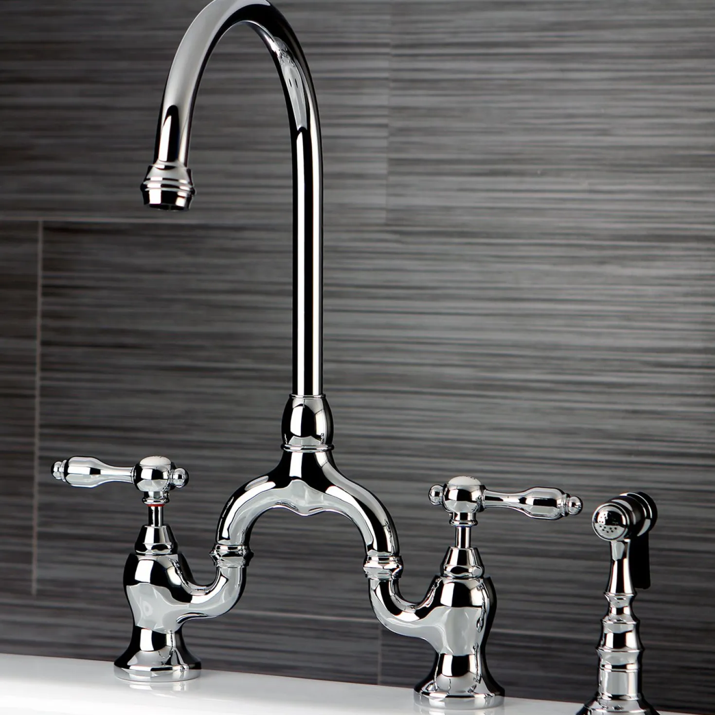 Kingston Brass Tudor Bridge Deck Mount Kitchen Faucet with Brass Sprayer