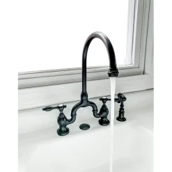 Kingston Brass Tudor Bridge Deck Mount Kitchen Faucet with Brass Sprayer