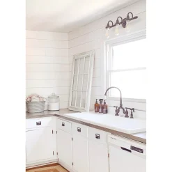 Kingston Brass Tudor Bridge Deck Mount Kitchen Faucet with Brass Sprayer