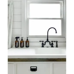 Kingston Brass Tudor Bridge Deck Mount Kitchen Faucet with Brass Sprayer