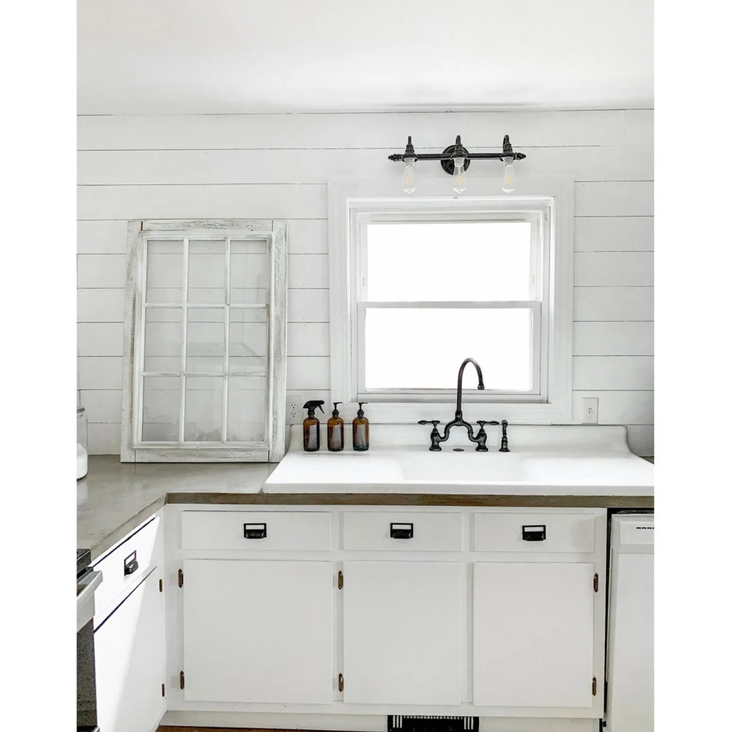 Kingston Brass Tudor Bridge Deck Mount Kitchen Faucet with Brass Sprayer
