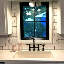 Kingston Brass Tudor Bridge Kitchen Faucet with Brass Sprayer