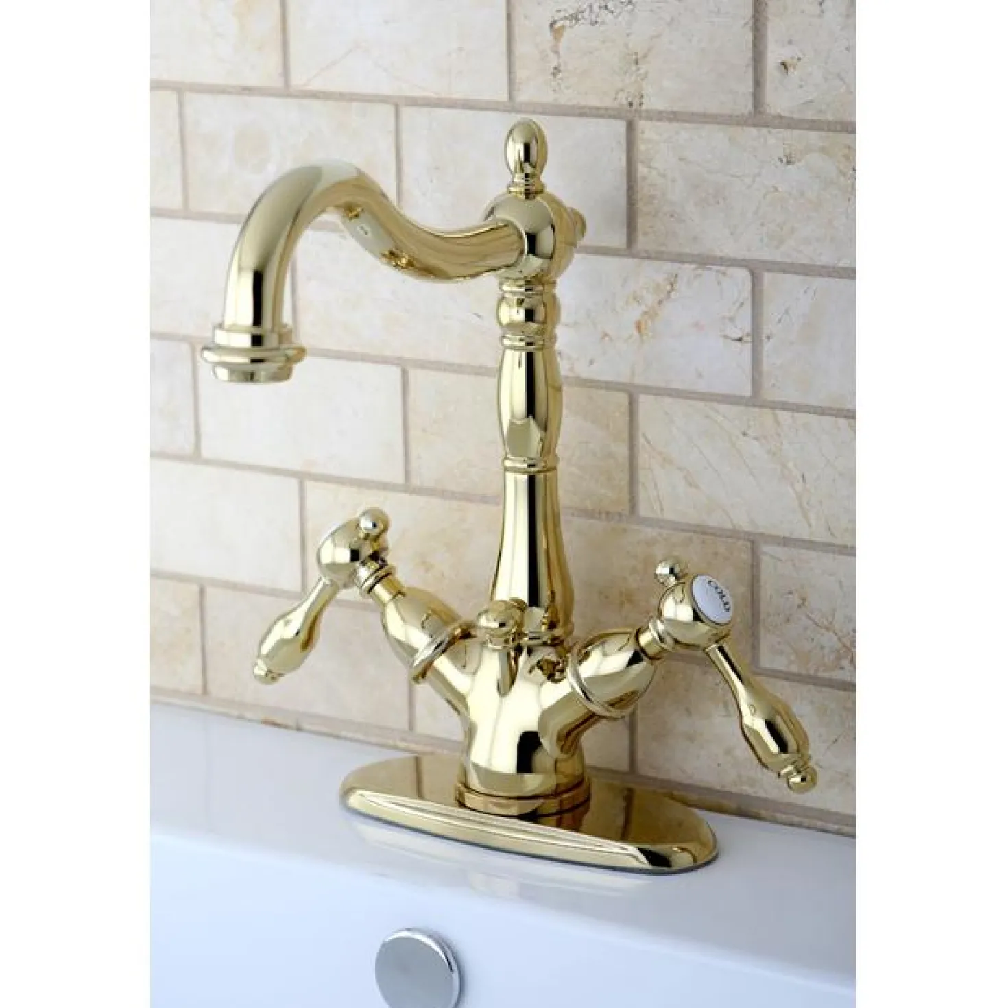 Kingston Brass Tudor 4" Center Lavatory Faucet with Brass Pop-up in Polished Brass