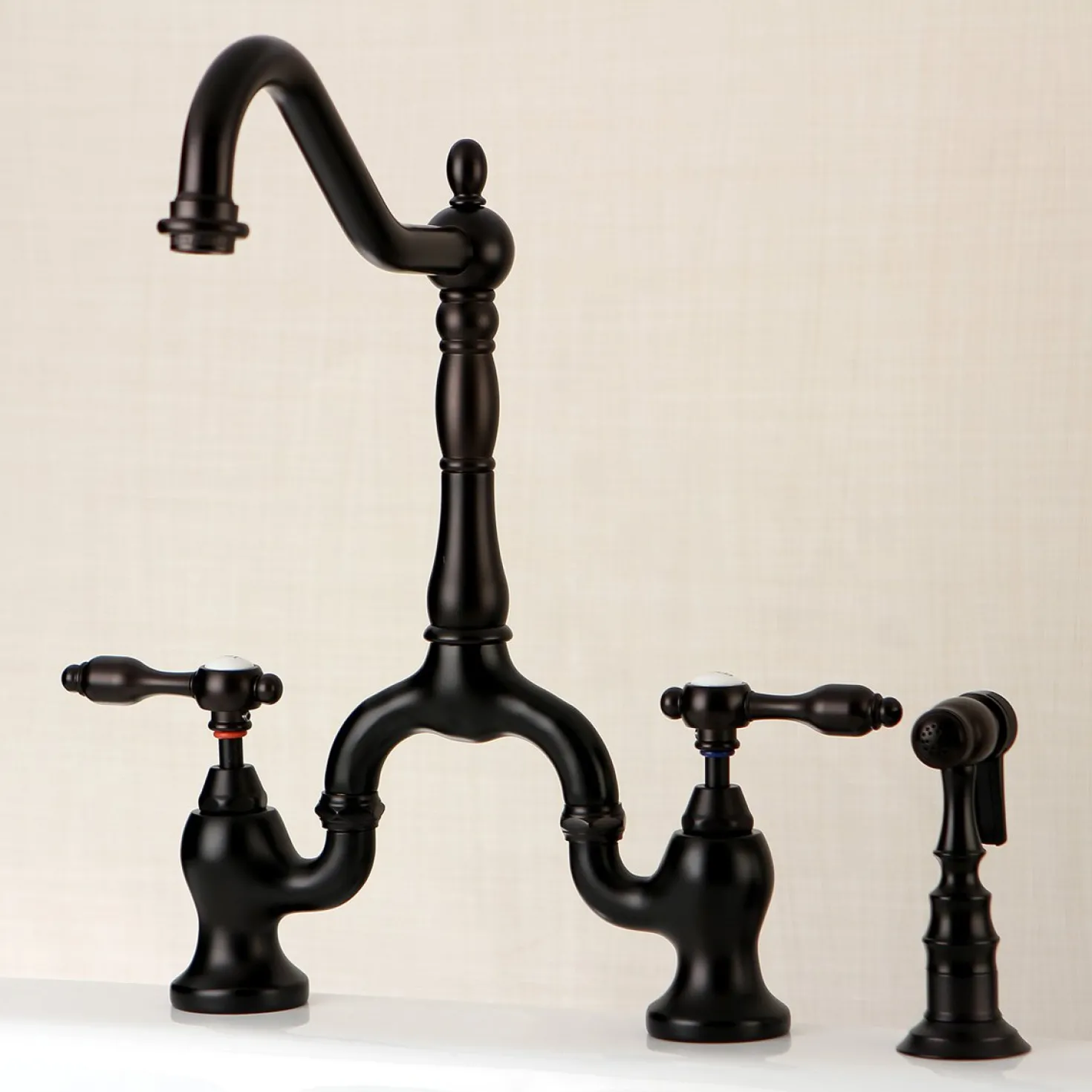 Kingston Brass Tudor Deck Mount Bridge Kitchen Faucet with Brass Sprayer