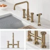 KRAUS Urbix Bridge Kitchen Faucet with Side Sprayer in Brushed Gold