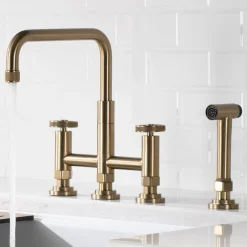 KRAUS Urbix Bridge Kitchen Faucet with Side Sprayer in Brushed Gold